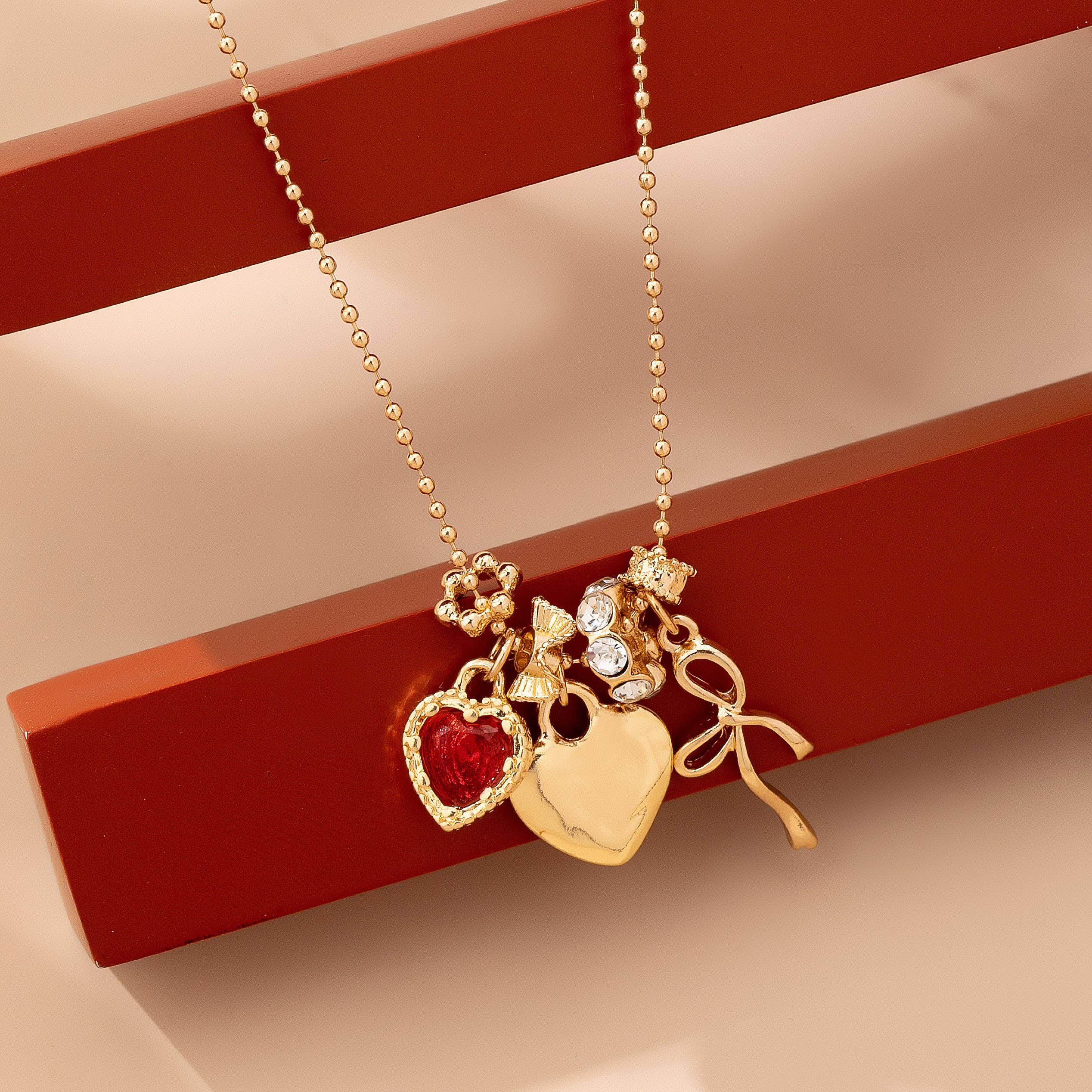 Multi-Charm Heart and Bow Necklace | 80N92882: Gold