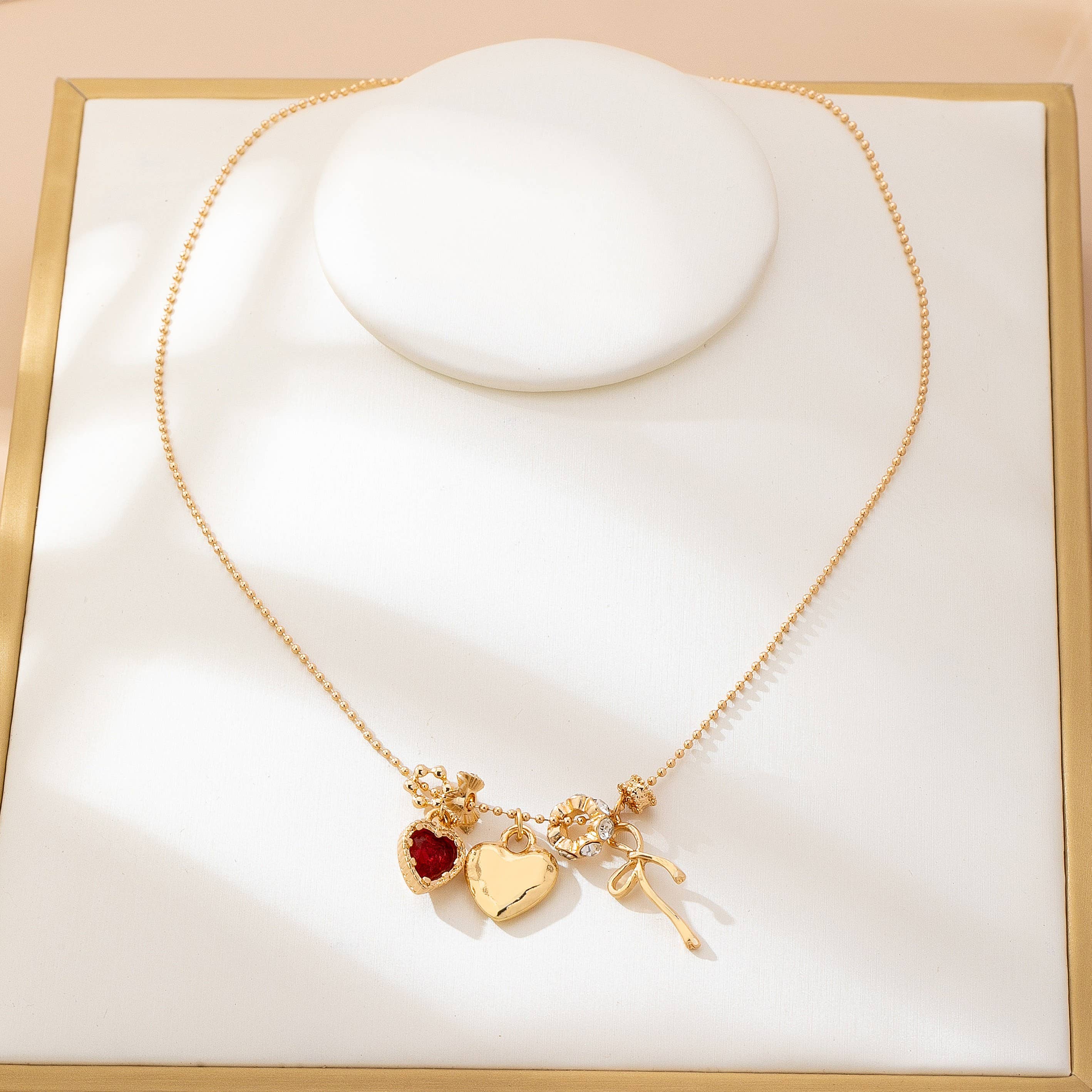 Multi-Charm Heart and Bow Necklace | 80N92882: Gold